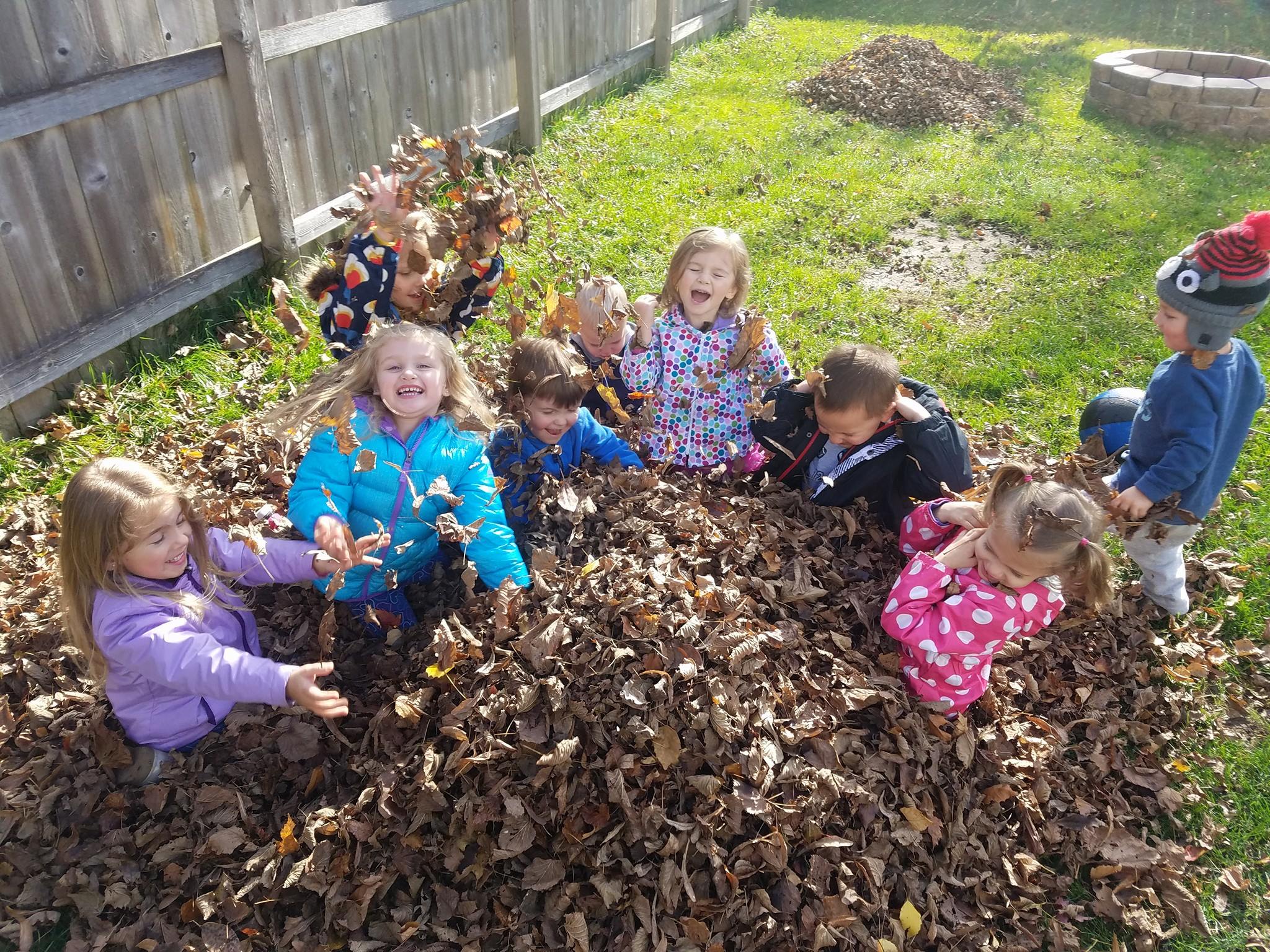 kids-playing-in-leaves-at-lauras-daycare-in-eagan-mn-laura-s-little